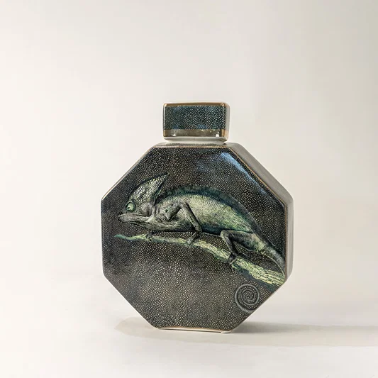 Green ceramic decorative jar with textured glaze and geometric form for elegant tabletop styling and home decor.