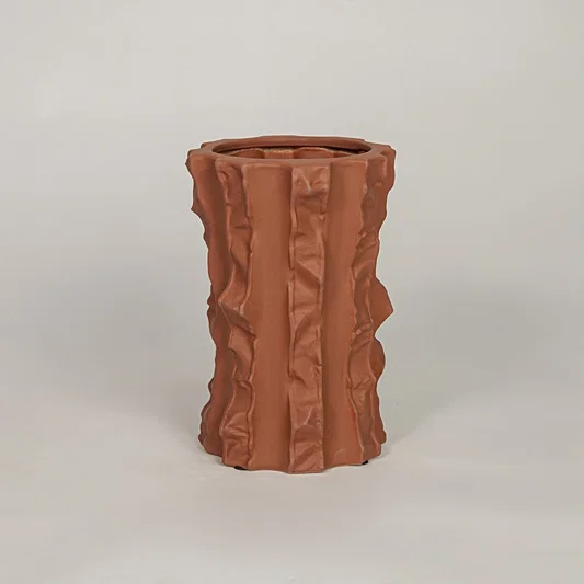 Terracotta ceramic decorative vase with sculpted textured design for modern tabletop shelf and console decor placement.