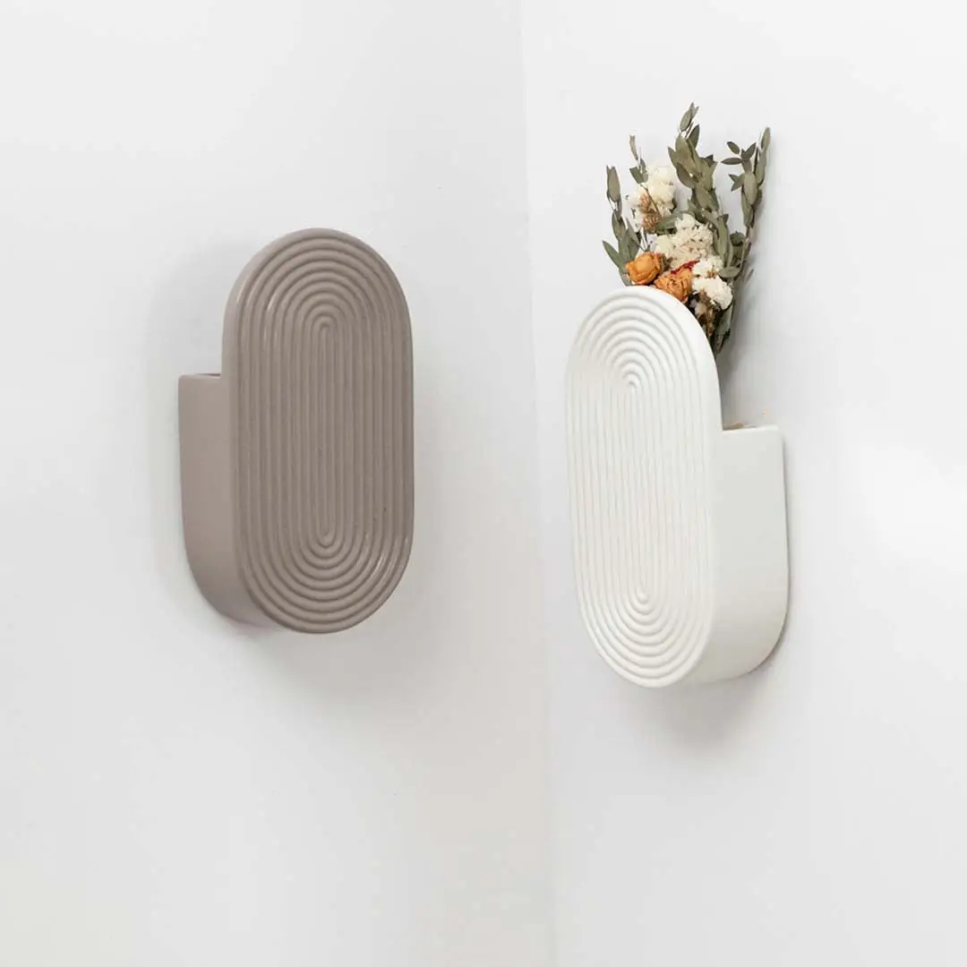 Sage green resin wall hook for entryway bedroom or bathroom wall decor with dried floral styling and modern storage appeal.
