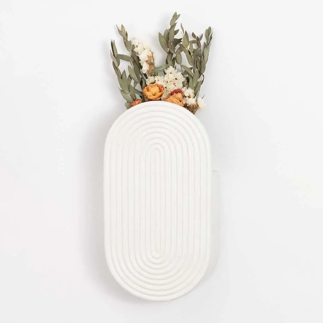 White ceramic wall vase with textured oval design shown against a clean background for modern home decor styling.