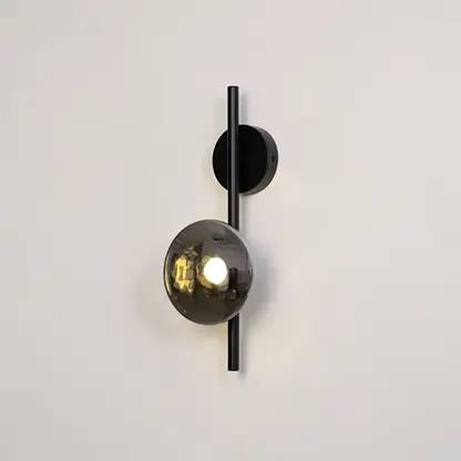 Black wall light with smoked textured glass shade illuminated on a bright white background for clear visibility.