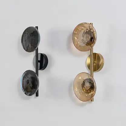 Gold double wall lights with amber textured glass globes shown on a bright white background with lights off for clarity.