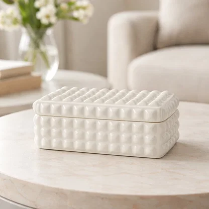 White ceramic textured storage box styled on center table enhancing minimalist home decor aesthetic.