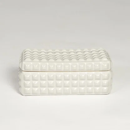 White ceramic textured storage box with geometric pattern and fitted lid isolated on white background for elegant decor use.