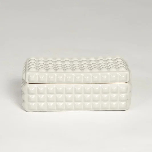 White ceramic textured storage box with geometric pattern and fitted lid isolated on white background for elegant decor use.