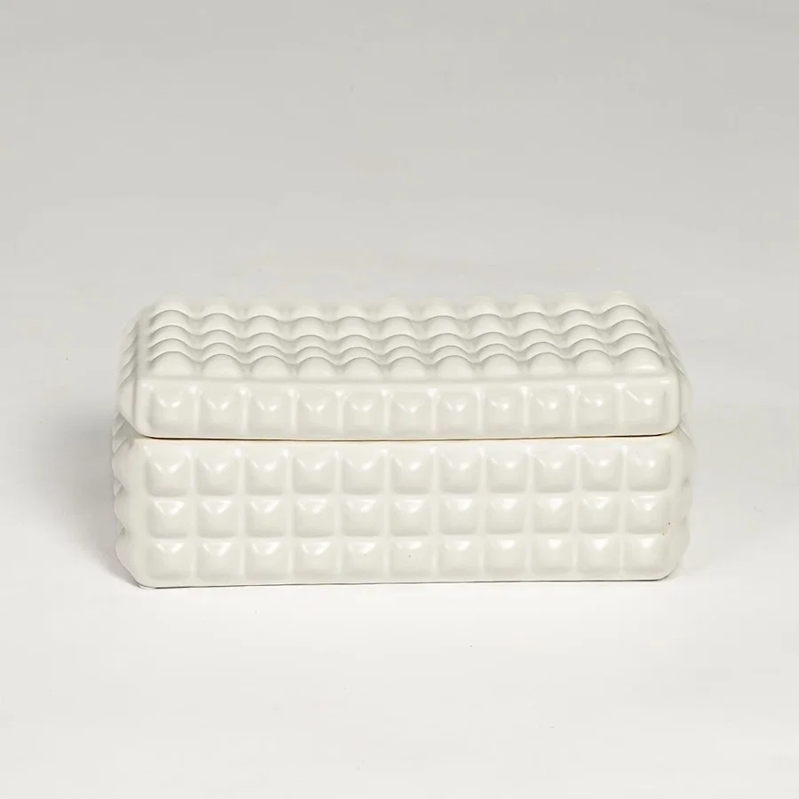 White ceramic textured storage box with geometric pattern and fitted lid isolated on white background for elegant decor use.