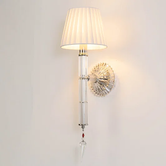 Contemporary metal wall light in chrome finish with fabric shade for bedroom or living room ambient lighting decor placement white background.