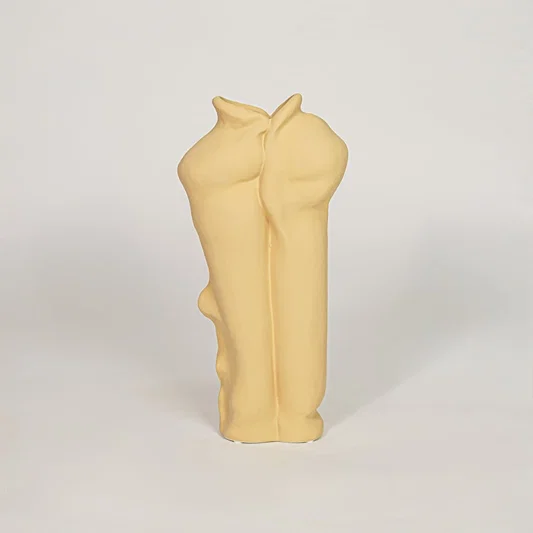 Beige ceramic abstract body vase with sculpted artistic design for modern tabletop shelf decor placement.
