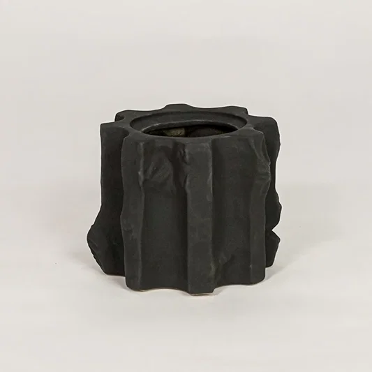 Black ceramic decorative vase with sculpted textured finish for modern tabletop shelf and console decor placement.