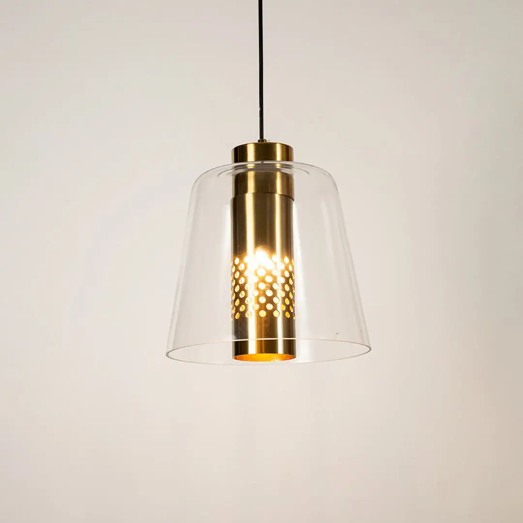 Clear glass pendant light with gold metal finish illuminated beautifully for elegant ceiling lighting decor.