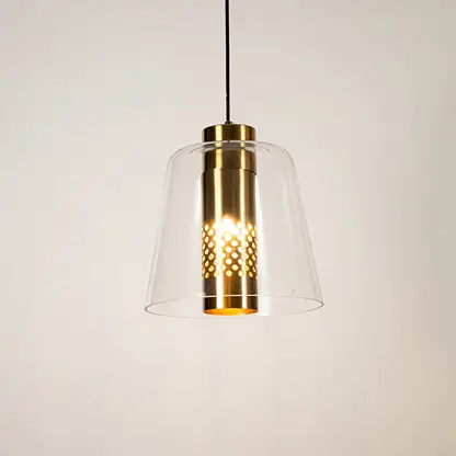 Clear glass pendant light with gold metal finish illuminated beautifully for elegant ceiling lighting decor.