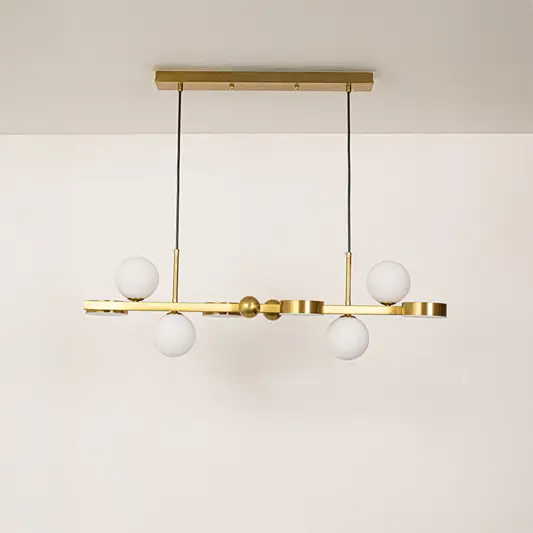 Gold metal chandelier with frosted glass globe shades designed for elegant modern ceiling lighting in stylish interiors.