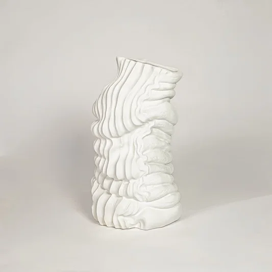 Modern white ceramic sculpted wave design decorative vase ideal for dried floral arrangement in living room corner and home decor styling.