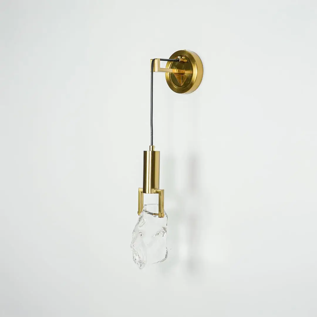 Gold metal wall light with crystal glass shade for elegant modern bedroom and hallway lighting decor styling.