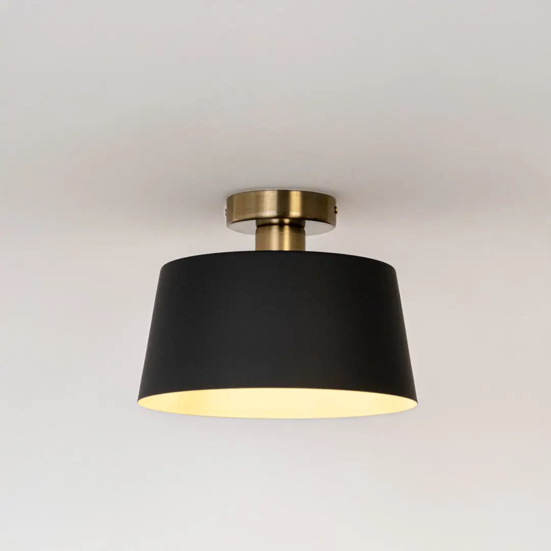 Modern black metal ceiling light with warm ambient glow for stylish bedroom and contemporary decor styling spaces.
