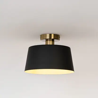 Modern black metal ceiling light with warm ambient glow for stylish bedroom and contemporary decor styling spaces.