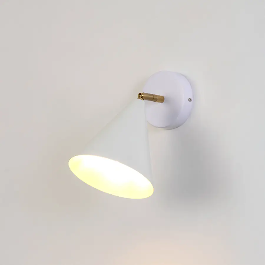 White metal wall light with dome shade and gold holder emitting warm glow ideal for bedroom or hallway wall decor placement.