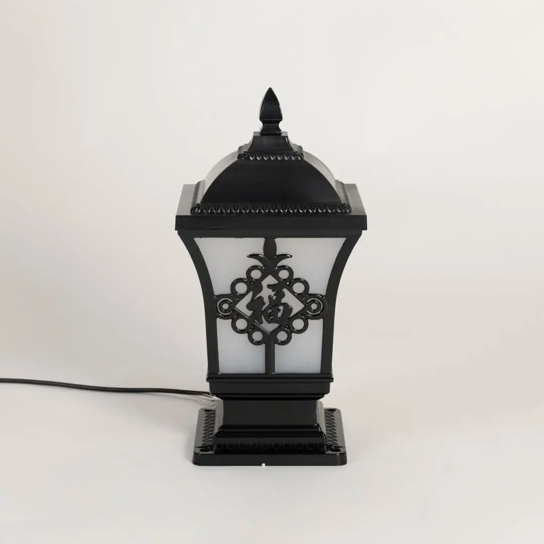 Black outdoor post light seeded glass Light Off Black Background style image showing the durable metal fixture next to a tree.