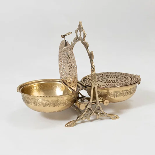 Decorative metal basket set in gold finish with handle for dining table or serving decor accessory placement white background.