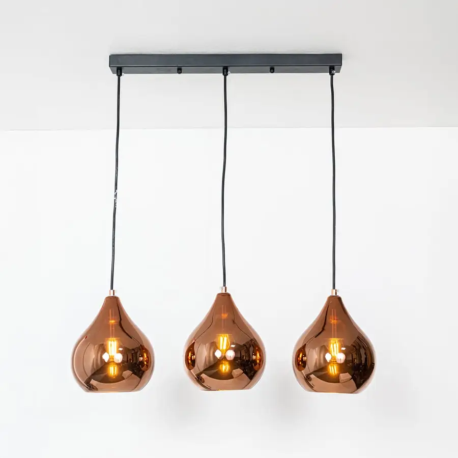 Amber glass pendant lights with metallic finish designed for stylish contemporary home decor spaces.