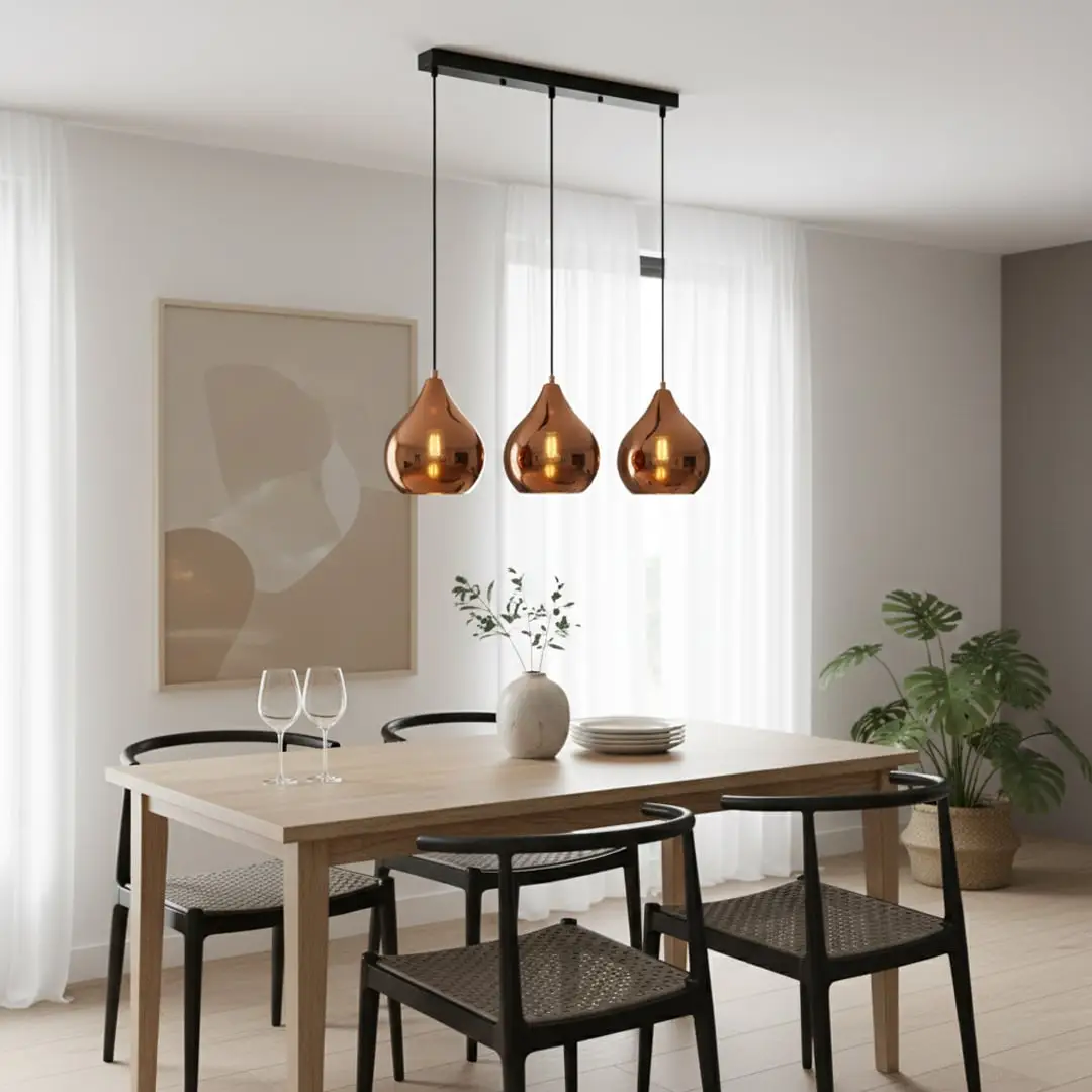 Amber glass pendant lights adding warm elegance above the dining table in modern interior spaces.