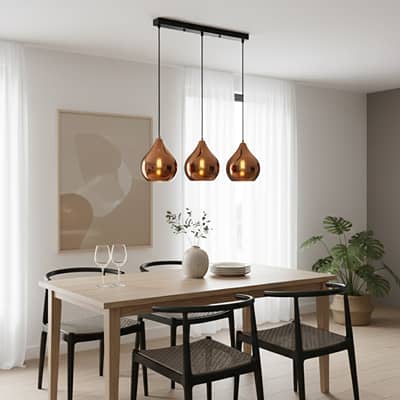 Amber glass pendant lights adding warm elegance above the dining table in modern interior spaces.