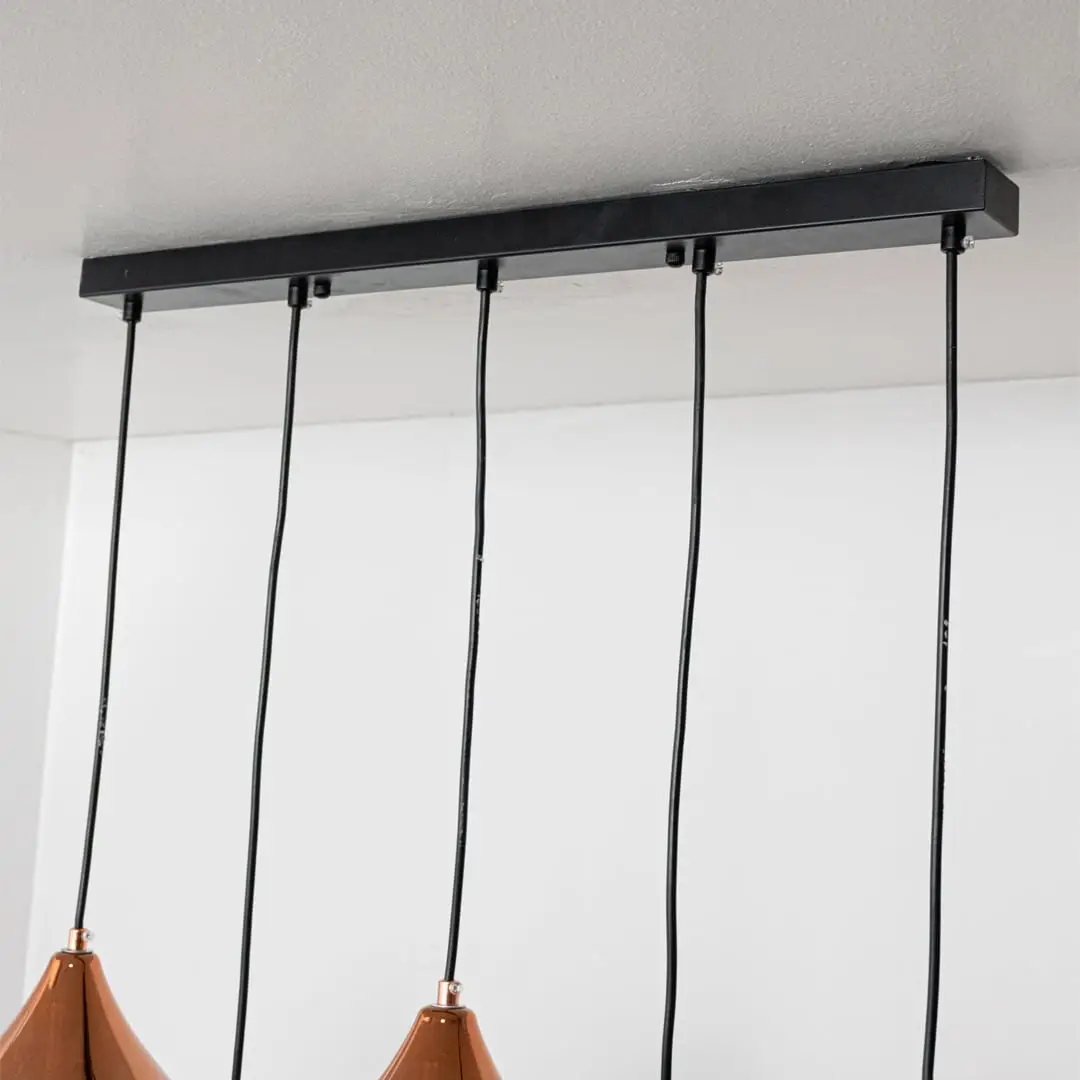 Black metal linear ceiling canopy with suspended cords highlighting sleek modern craftsmanship.