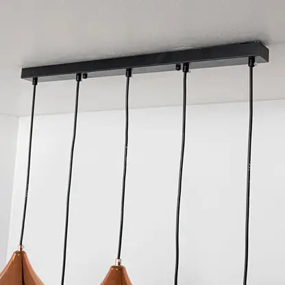 Black metal linear ceiling canopy with suspended cords highlighting sleek modern craftsmanship.