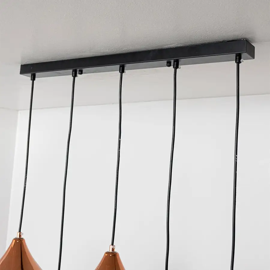 Black metal linear ceiling canopy with suspended cords highlighting sleek modern craftsmanship.