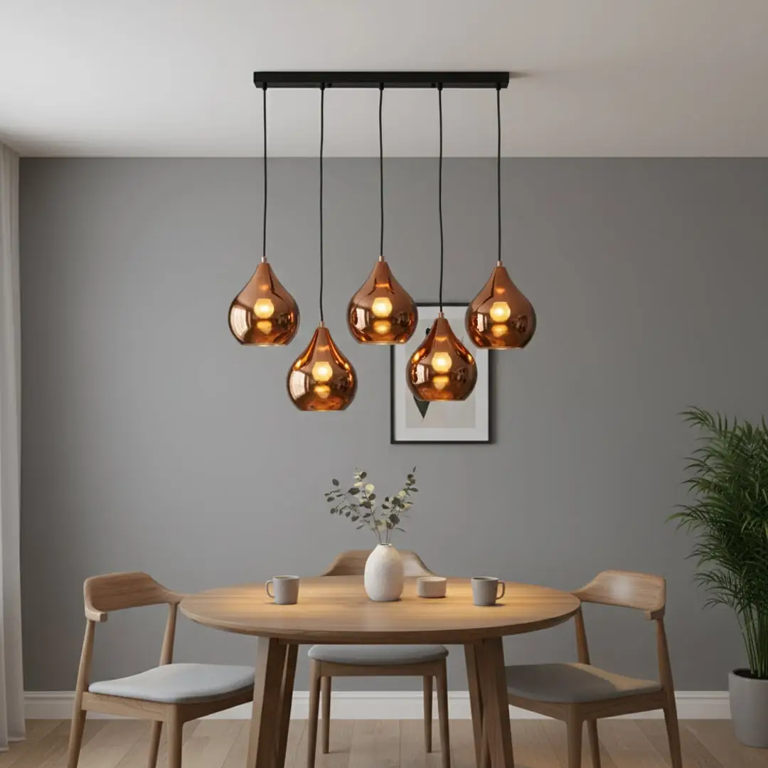 Amber metallic glass pendant lights adding warm elegance above the dining table in modern interiors.