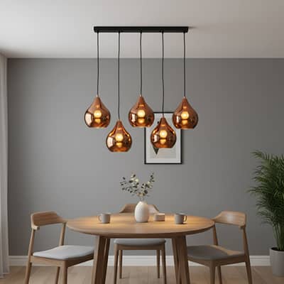 Amber metallic glass pendant lights adding warm elegance above the dining table in modern interiors.