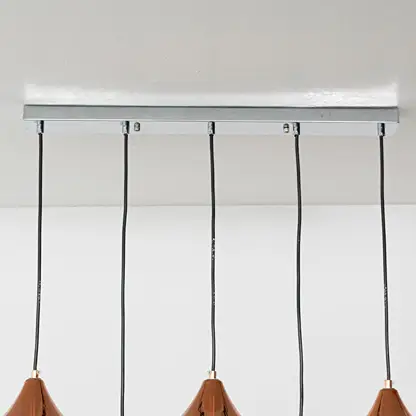Terracotta and amber glass pendant lights with black metal canopies for stylish modern home decor.