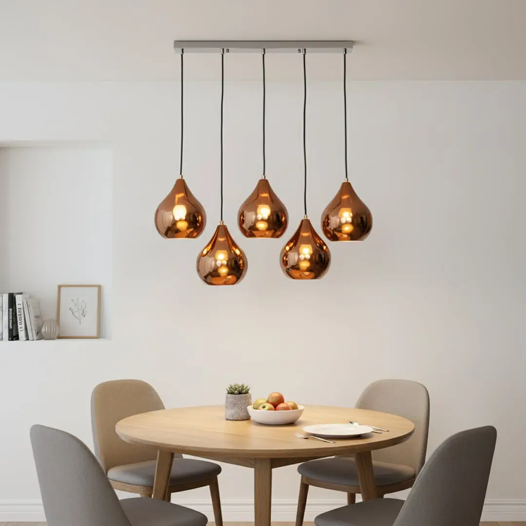 Amber metallic glass pendant lights creating cozy ambience above the dining table in elegant interiors.