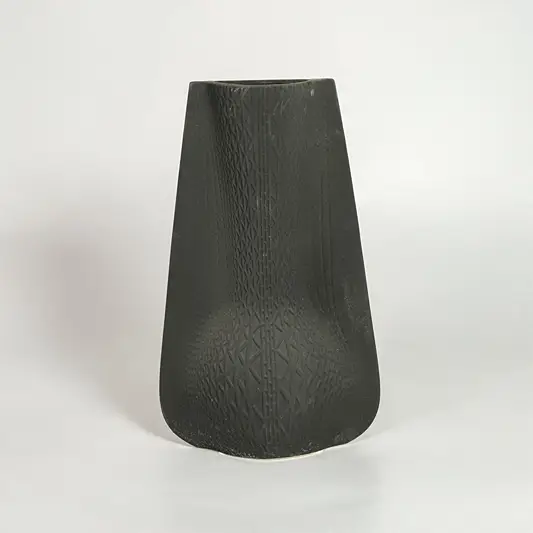 Black decorative ceramic vase on white background modern home decor accent piece for table floor console styling interior.