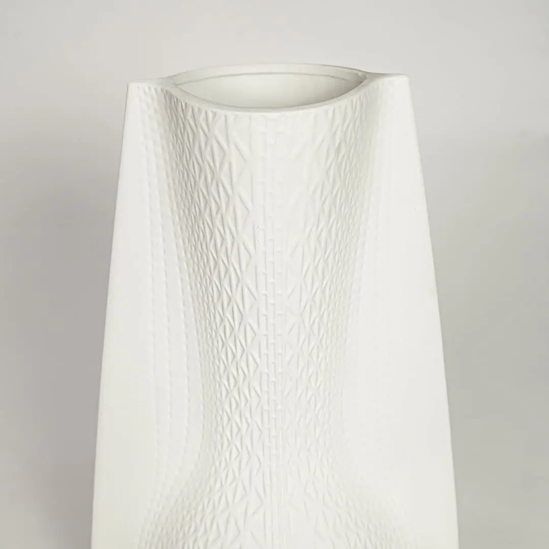 White ceramic decorative vase with textured diamond pattern for elegant tabletop styling and contemporary home decor.