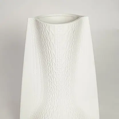 White ceramic decorative vase with textured diamond pattern for elegant tabletop styling and contemporary home decor.