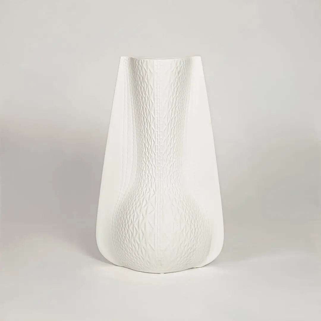 White ceramic decorative vase with soft curved silhouette for minimalist shelf styling and modern home decor.