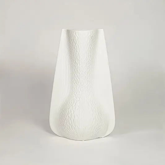 White ceramic decorative vase with soft curved silhouette for minimalist shelf styling and modern home decor.