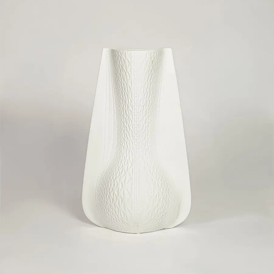 White ceramic decorative vase with soft curved silhouette for minimalist shelf styling and modern home decor.