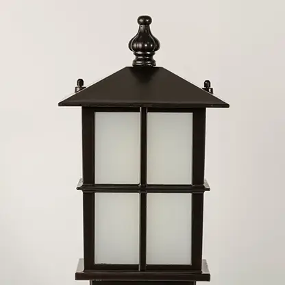 Closeup of black outdoor gate light with frosted glass panels for luxury exterior decor styling use.