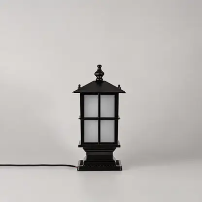 A black outdoor-style lantern light with frosted white glass panels, shown standing on a light gray background with a black power cord extending to the left.