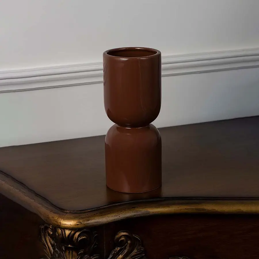 Brown ceramic vase with glossy finish placed on a white background for modern home and office decor.