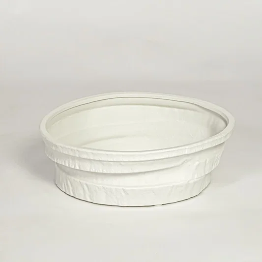 White ceramic round decorative tray with textured rim and smooth interior isolated on clean white background for modern decor styling.