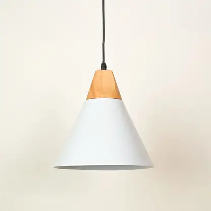 A modern cone-shaped pendant light with a white metal shade and a natural light wood accent at the top, suspended by a black cord against a warm off-white background.