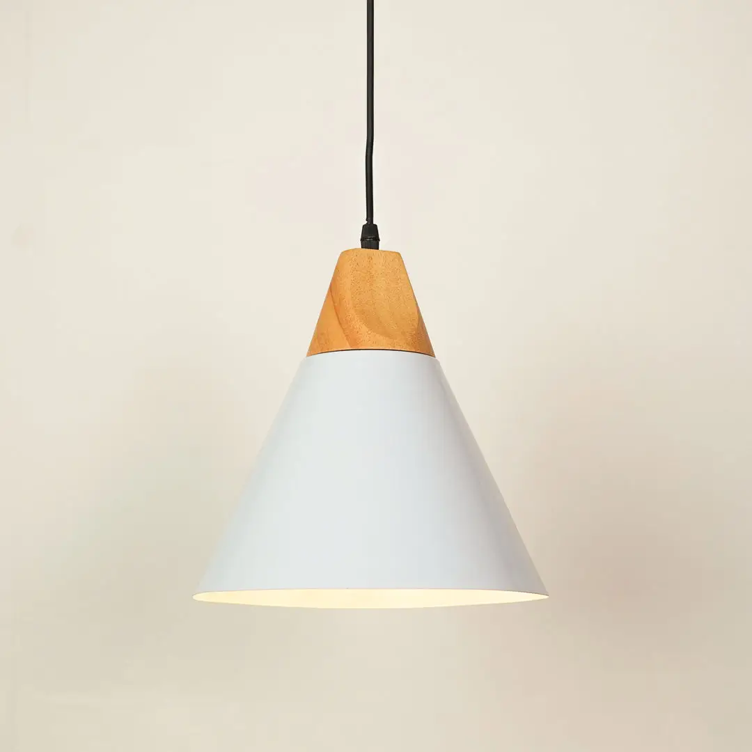 A modern cone-shaped pendant light with a white metal shade and a natural light wood accent at the top, suspended by a black cord against a warm off-white background.