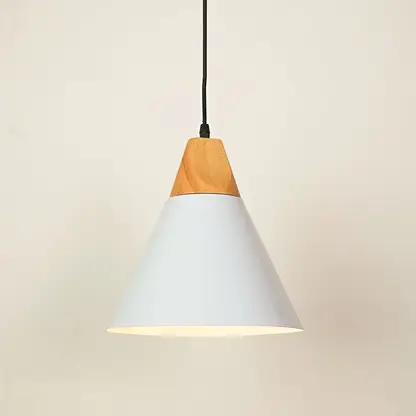 A modern cone-shaped pendant light with a white metal shade and a natural light wood accent at the top, suspended by a black cord against a warm off-white background.