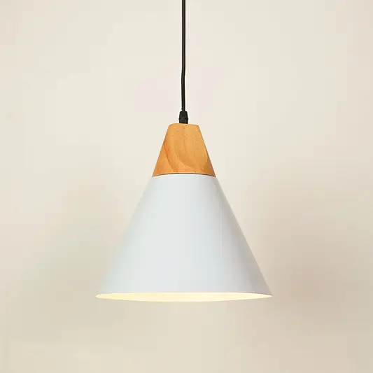 A modern cone-shaped pendant light with a white metal shade and a natural light wood accent at the top, suspended by a black cord against a warm off-white background.