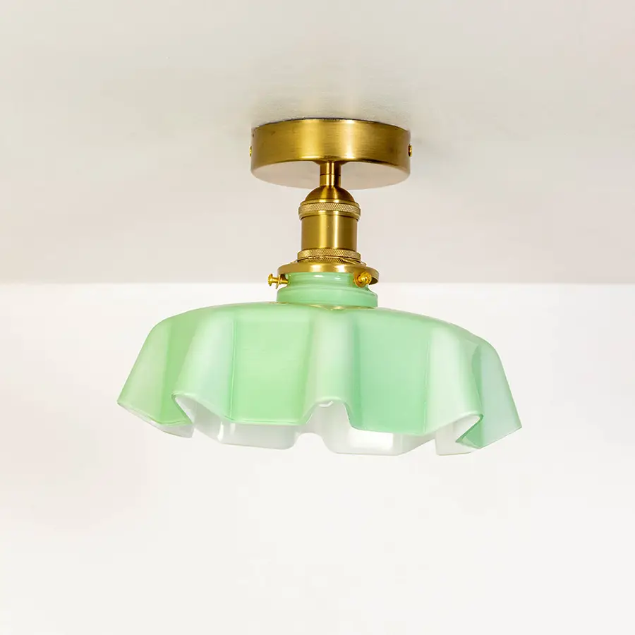 Closeup of mint green glass and gold metal ceiling light for luxury home decor and modern interior styling spaces.