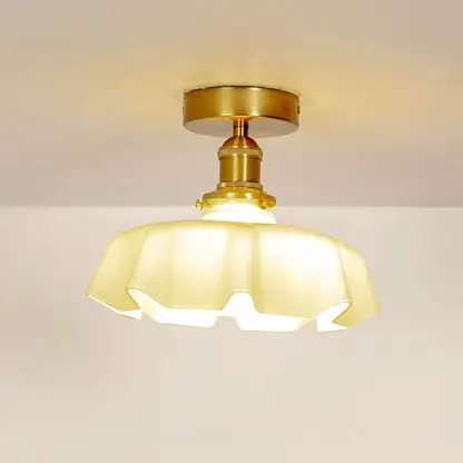 Mint green ruffled ceiling light shown off on a white background with a smooth gold mount.