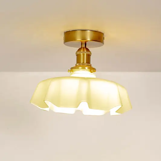 Mint green ruffled ceiling light shown off on a white background with a smooth gold mount.